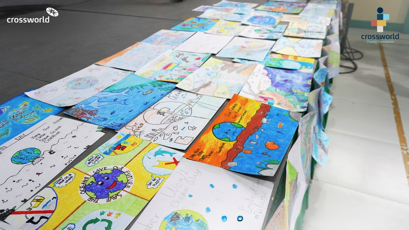 Students presenting their marine-environment posters at the Adopt-A-Ship Poster-Making Contest